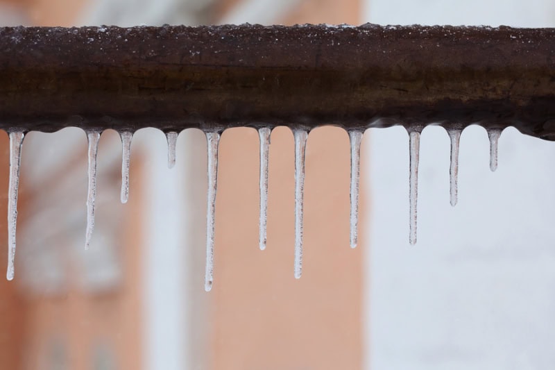 What Should I Do About Frozen Pipes? Photo of icicles hanging from a water pipe.