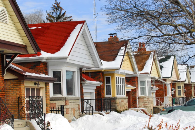 Prepping Your Plumbing for Winter. Row of residential houses in winter with snow