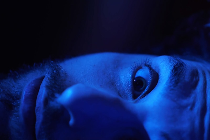 Video - Is your AC making scary noises? Close up of man's face in blue lighting.